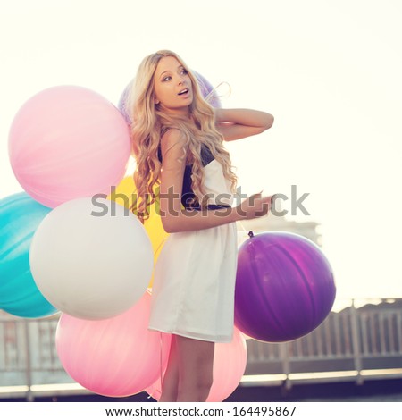 Happy Young Woman With Big Colorful Latex Balloons Against The Evening Sun Going Down. Pastel Colors. Outdoors, Lifestyle