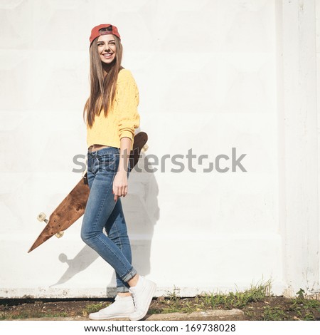 Beautiful young girl hipster walking with longboard in the afternoon Skateboarding Outdoors lifestyle Beautiful young girl hipster walking with longboard in the afternoon Skateboarding Outdoors lifestyle