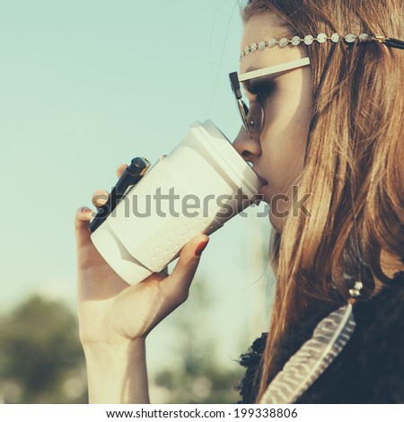 Hipster girl in sunglasses with drink coffee. Close-up lifestyle outdoor portrait