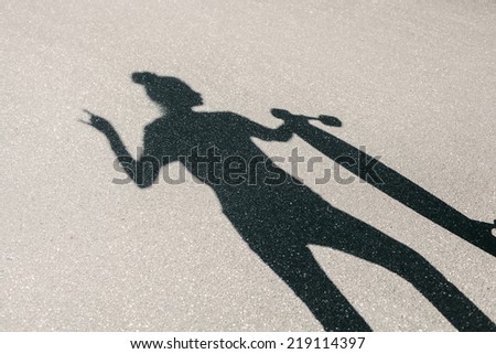 Beautiful and fashion young woman posing with a long board. Shadow of girl with a skateboard.