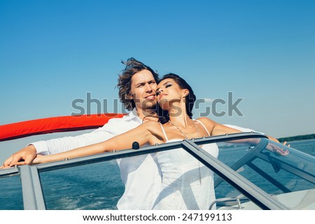 Young couple loving each other. Beautiful man and woman on a sea voyage on a yacht.