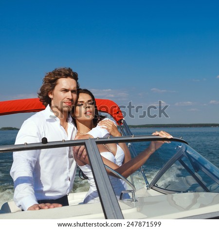 Young couple loving each other. Young family on a sea voyage on a yacht.