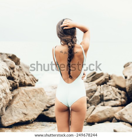Girl standing on coastal sea rocks. Well being healthy lifestyle