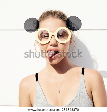 young girl in sunglasses showing tongue. hipster have fun. teen. lifestyle.