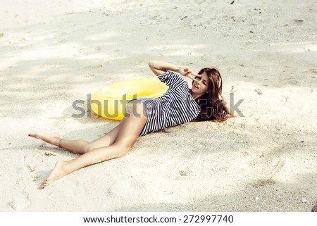 attractive woman having fun, outdoor shot in sand, summer day