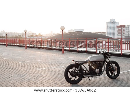 Vintage custom caferacer motorcycle in the parking lot during sunset. Outdoors lifestyle
