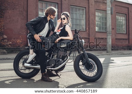 Sexy couple of bikers on the vintage custom motorcycle. Outdoor lifestyle portrait