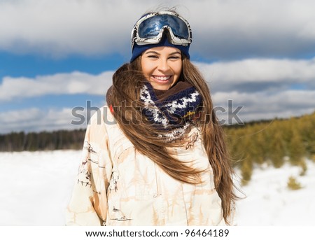 Young beautiful girl are enjoying the sun and snow