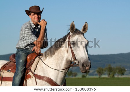 Nice young cowboy posing on his horse