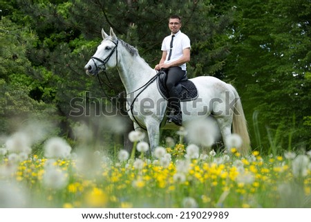 Portrait of a young man on his horse