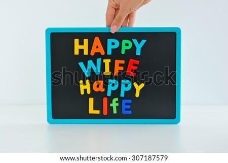 Happy wife happy life with magnetic colored letter blocks on blackboard