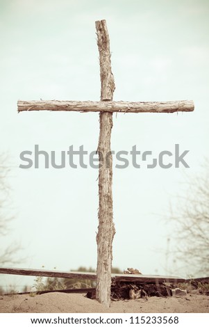 Wooden Cross - This is a photo of a man made wooden cross shot outside in a desaturated color tone.