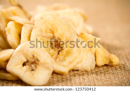 Banana - This is a macro shot of a pile of dried banana chips. Shot with a shallow depth of field and slight vignetting.