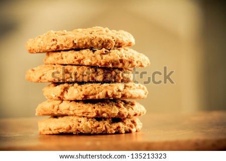 Cookies - This is a stack of cookies shot on a wooden table top. Shot with a shallow depth of field and a warm retro color tone.