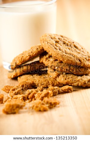 Cookies - This is a photo of a pile of oatmeal cookies with crumbs on a wooden cutting board. Shot with a shallow depth of field.