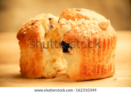 Blueberry Muffin - This is a close up shot of a blueberry muffin ripped in half. Shot in a warm retro color tone with a shallow depth of field.