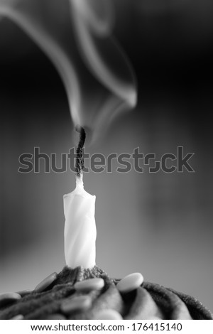 Blown Out Candle - This is a high contrast black and white photo of a blown out birthday candle with smoke. Shot with a shallow depth of field with the focus on the candle.