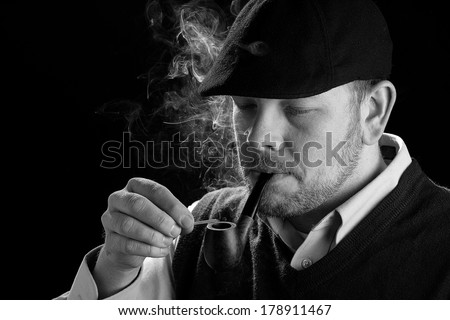 Man Holding Cigar - This is a high contrast black and white image of a young man holding a cigar. Shot on an isolated white background processed slightly to enhance detail.