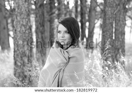 Woman Wrapped In Blanket - This is a black and white photo of a cute young woman wrapped in a warm blanket on a cool fall day. Shot with a shallow depth of field.