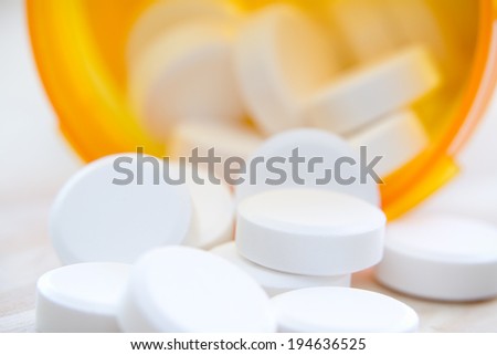 Pills - This is a shot of prescription pills spilling out of a bottle. Shot with a very shallow depth of field.