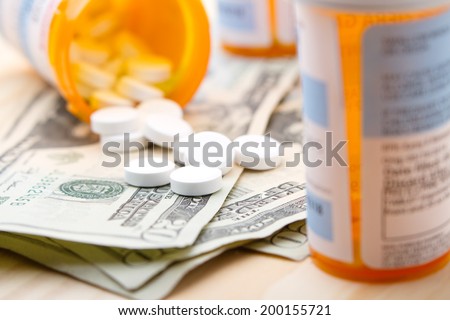 Substance Abuse - This is a shot of prescription pain pills spilled out on money to portray substance abuse.