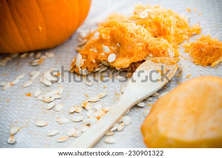 Pumpkin Carving - This is a shot of a pumpkin carving scene with all the seeds laying out on the table.
