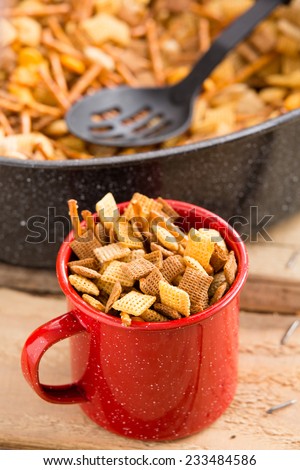 Party Snack Mix - This is a shot of a red mug filled with a holiday party mix. Shot with a shallow depth of field.