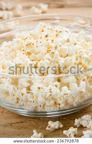 Bowl Of Popcorn - This is a shot of a glass bowl full of hot air popped popcorn on a wooden table. Shot with a shallow depth of field.