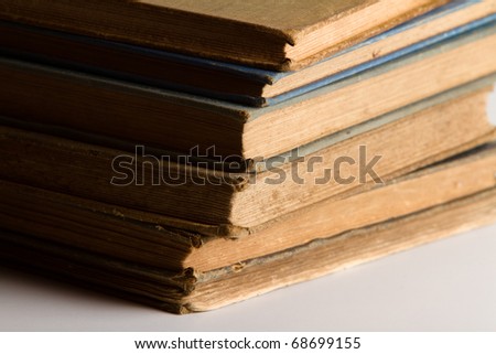 This is a close up shot of a stack of old books shot with a hard light source.