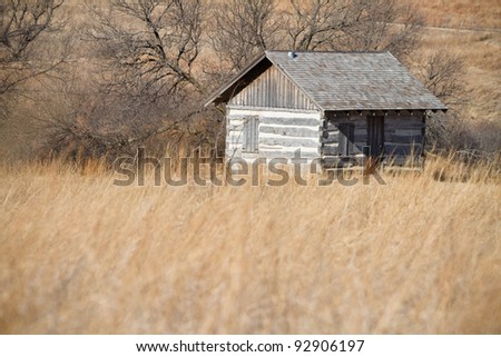 Cabin - This is a photo of an old log cabin sitting alone in a prairie.