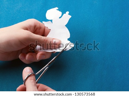 women\'s hands are cut from paper angel