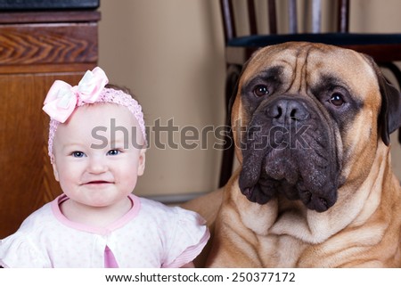 Portrait of a big dog and a little girl