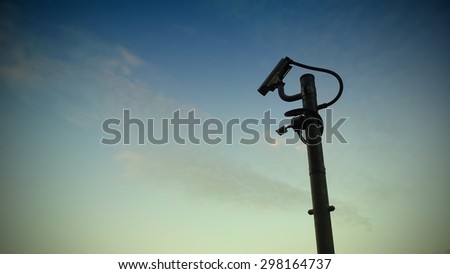 Security camera CCTV video surveillance on sunset background