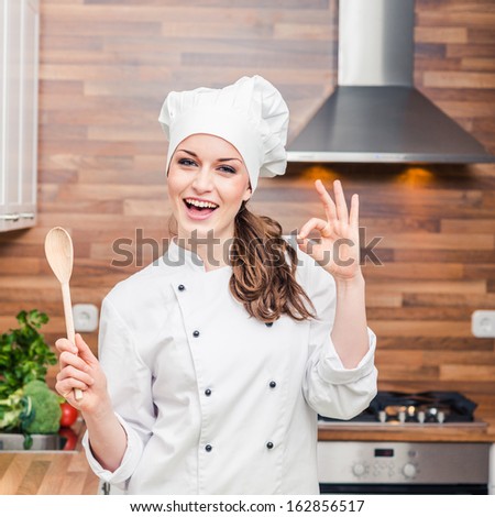 Young Woman Chef Cooking Cake In Kitchen