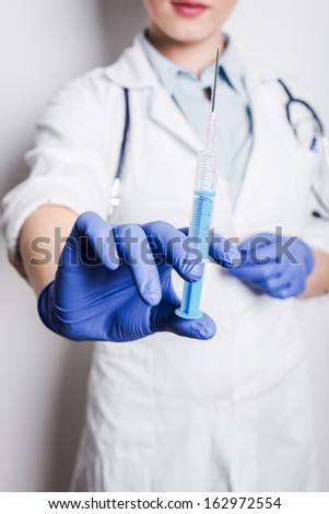 syringe needle close up with surgery woman doctor isolated on white background