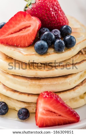 Pancake. Crepes With Berries. Pancakes stack with Strawberry, Blueberry and Syrup isolated on a White Background