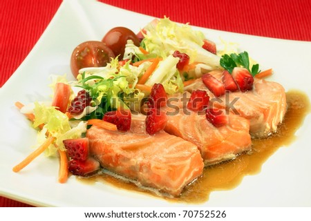 salmon and strawberry salad, tomatoes, lettuce and carrots