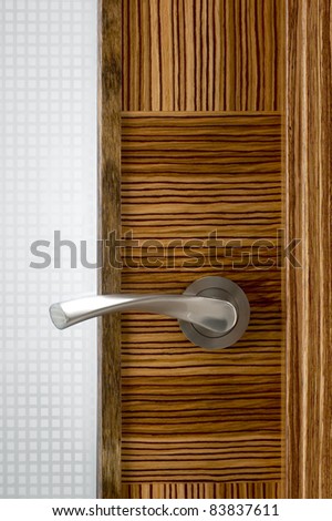 Door knob on the wooden door. Close up