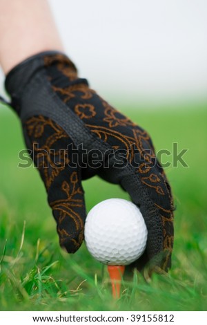 lady hand and golf ball. Vertical composition