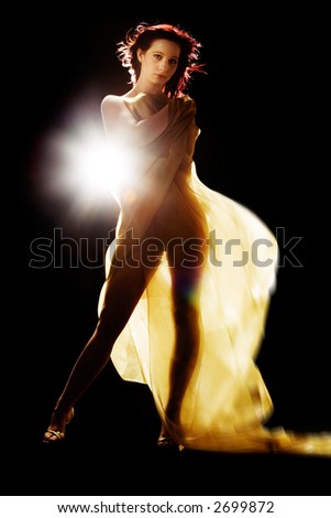 Model with sheer glittery cloth in studio