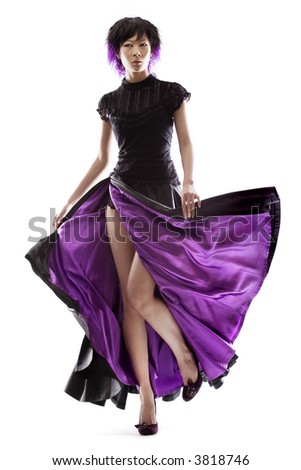 stock photo Stunning Asian fashion model in purple lined skirt