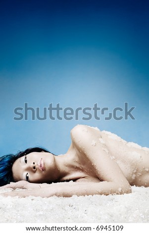 Asian beauty lays on bed of ice