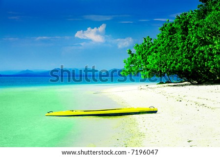 Kayak on white sandy beach in tropical paradise