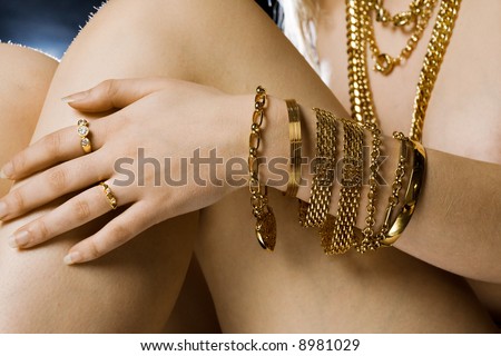 Model close up with lots of gold jewellery