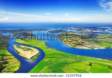 Aerial view of coastal waterways, blue sky and ocean in background