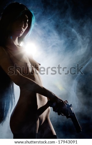 stock photo Naked beauty holding gun with smoke in background