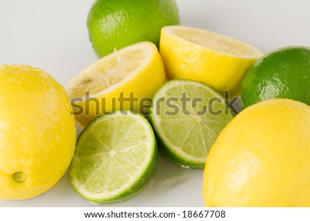 Refreshing lemons and limes on white background