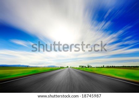 Road going straight ahead with motion blur