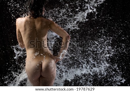 Naked body with water splashing over it