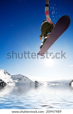 Crossover snowboard, surfing photo with boarder jumping into water